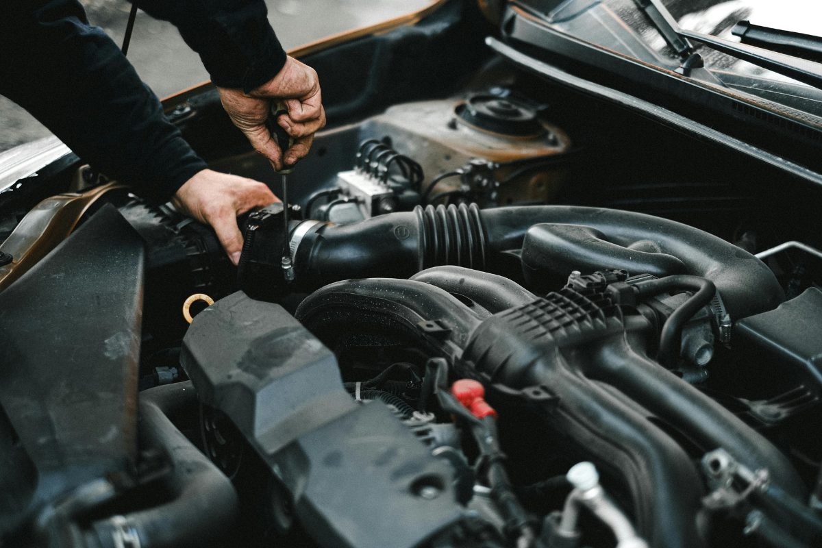 Commercial vehicle fleet maintenance technician checking engine oil